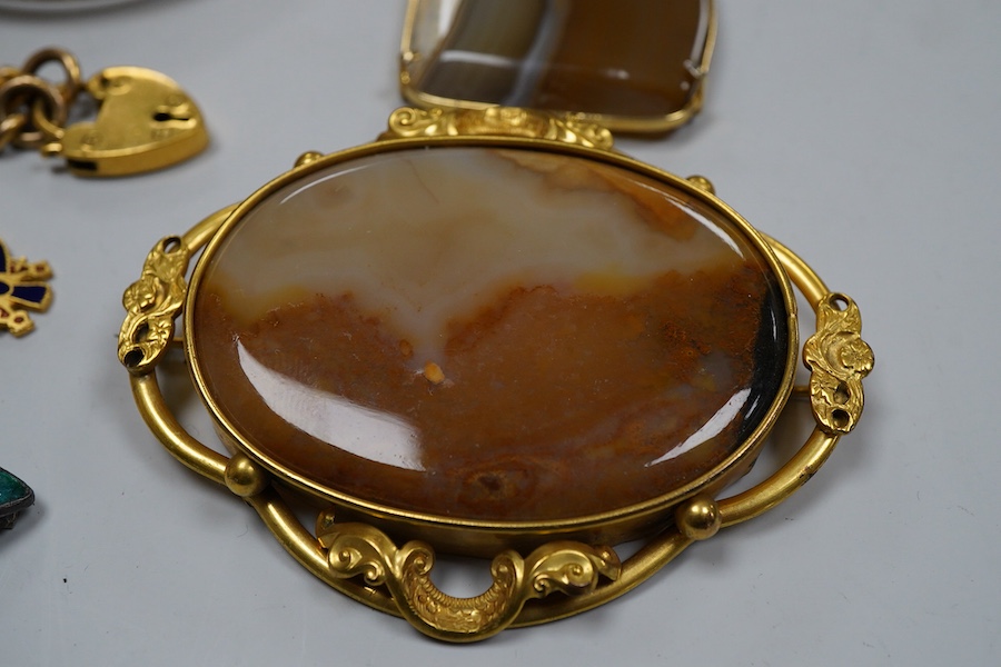 A group of gilt metal / pinchbeck jewels and an Arts & Crafts brooch by William Hair Haseler, comprising: a hinged bangle; an enamelled pendant in the Egyptian revival style; a gold curb link bracelet with a heart-shaped